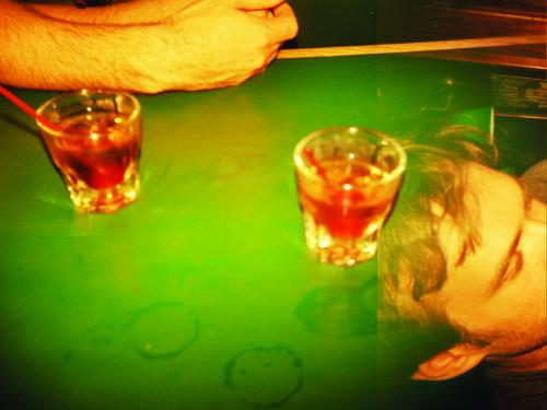 Two drinks on a pool table with man's head. Photo courtesy of Annie DeWitt