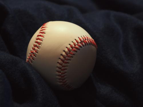 Horizontal close up of a baseball.