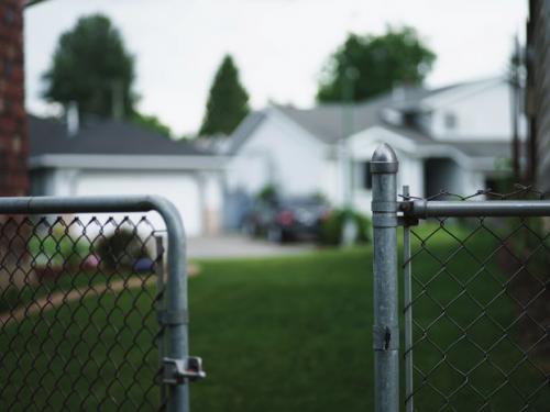 Photo of open gate of chainlink fence.