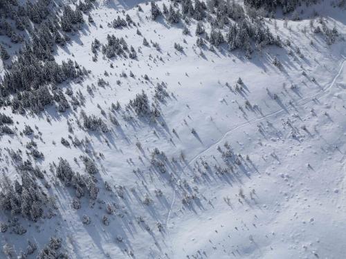 Horizontal photo of an aerial view of a snowy mountain