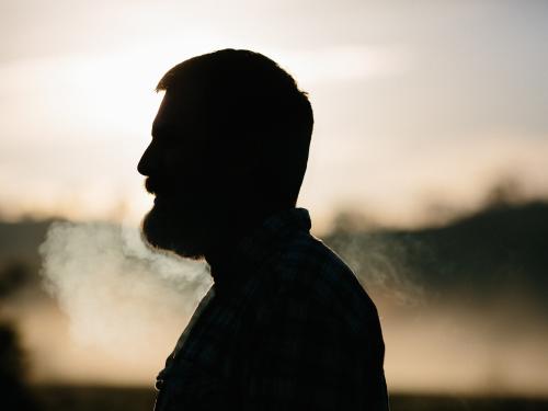 Horizontal photo of a man’s profile that is also a silhouette. 