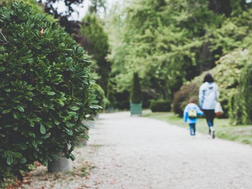 Horizontal photo blurred photo of a mother and child walking. 